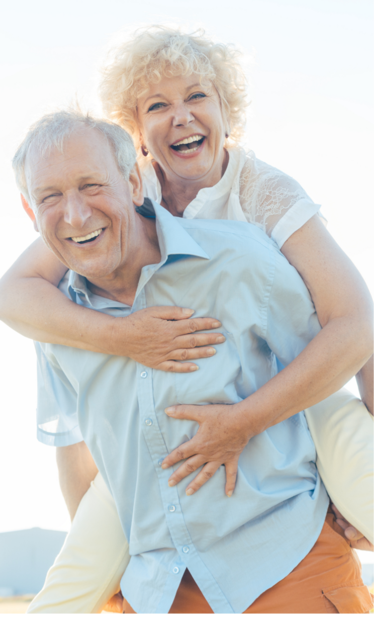 Happy retired couple on beach