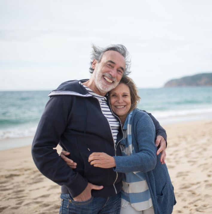 Happy retired couple on beach